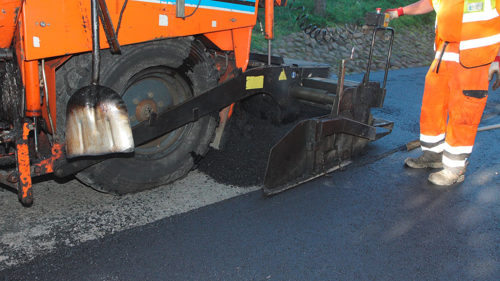 asfalttikone ja asfalttimies hommissa