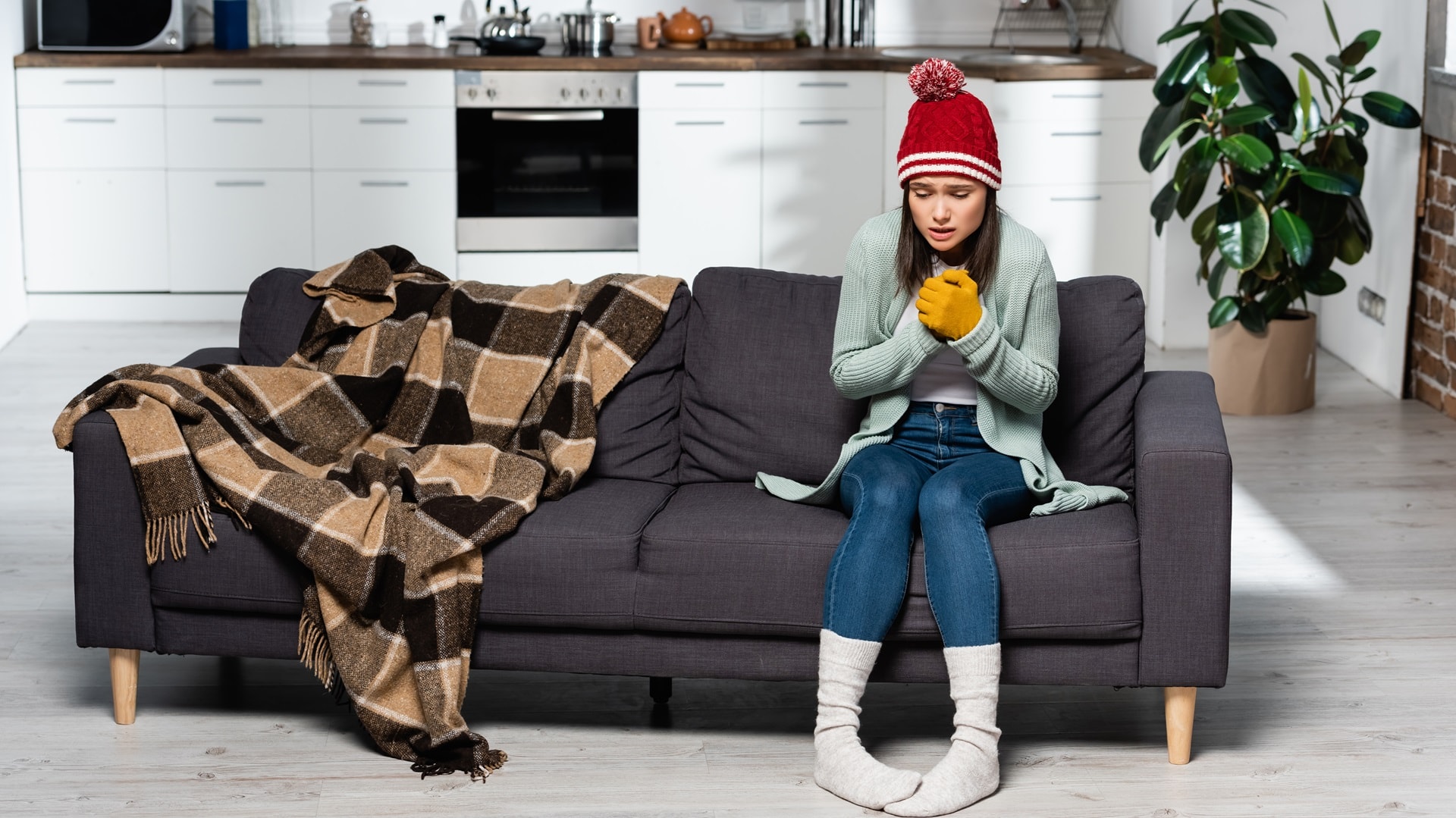 shivering-woman-in-warm-hat-gloves-and-socks-sitt-2024-11-09-09-08-21-utc